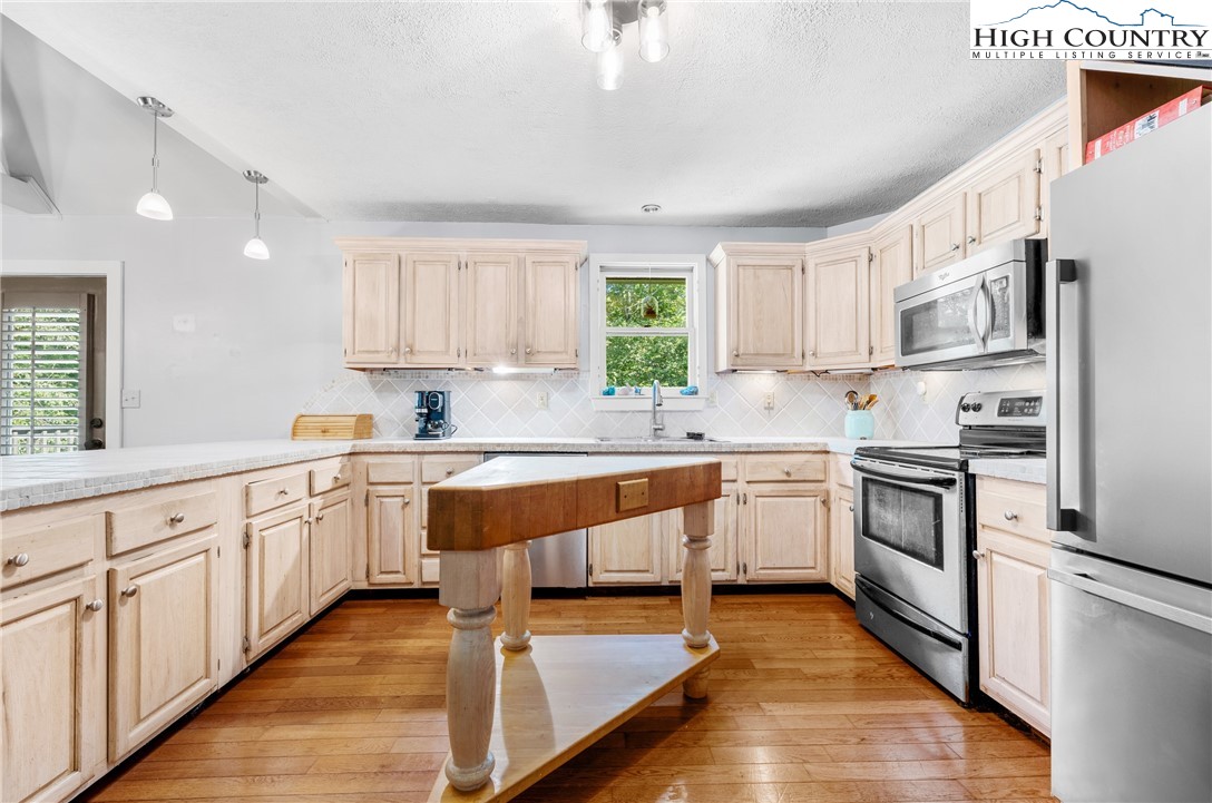 239 Deerfield Estates Road Boone, NC 28607 - Photo 15 of 45 a kitchen with granite countertop white cabinets and white appliances