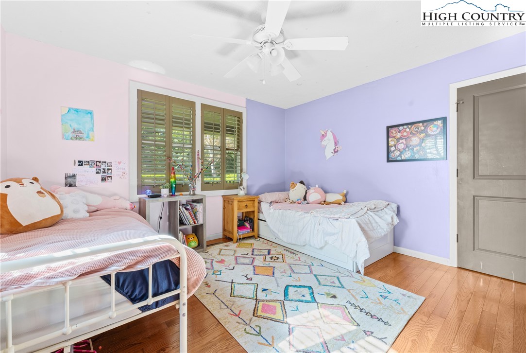 239 Deerfield Estates Road Boone, NC 28607 - Photo 22 of 45 a bedroom with a bed and wooden floor