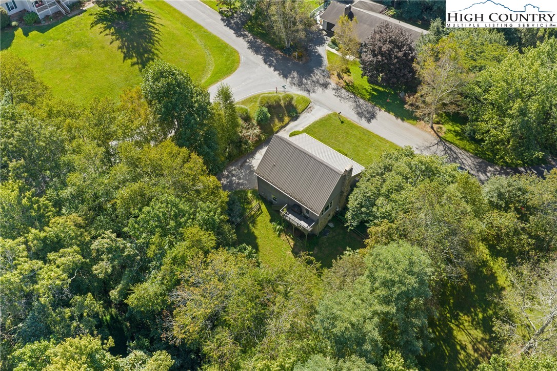 239 Deerfield Estates Road Boone, NC 28607 - Photo 39 of 45 an aerial view of a house with a yard and swimming pool