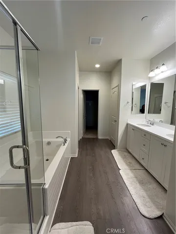 a bathroom with a tub sink and mirror