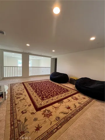 a bedroom with a bed and a lamp