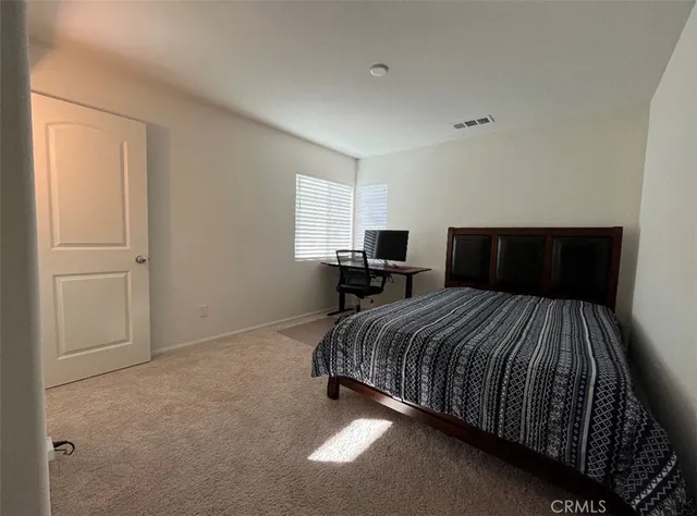 a bedroom with a bed and window