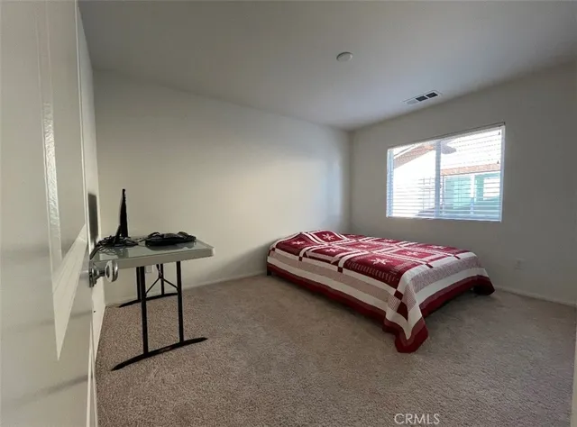 a bedroom with a bed and a table