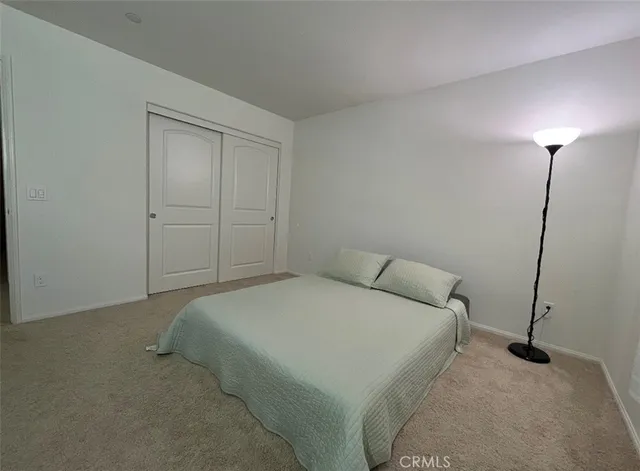 a bedroom with a bed and a night stand