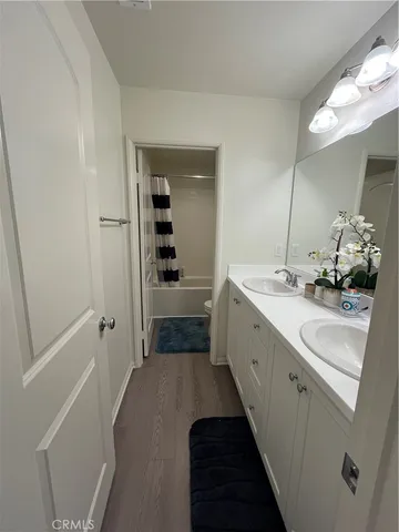 a spacious bathroom with a double vanity sink and mirror