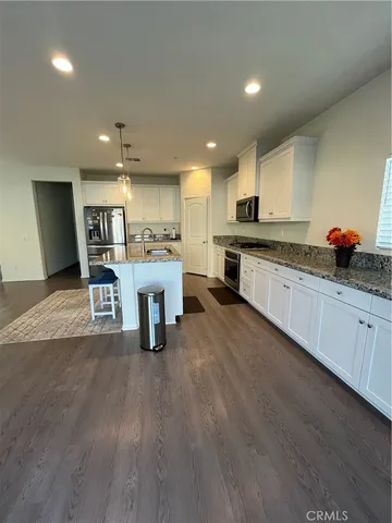 a large kitchen with lots of counter space and stainless steel appliances