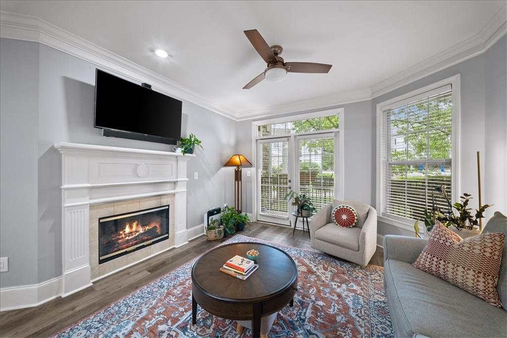 4100 Paces Walk Southeast, Unit 1101 Atlanta, GA 30339 - Photo 7 of 36 a living room with furniture a flat screen tv and a fireplace