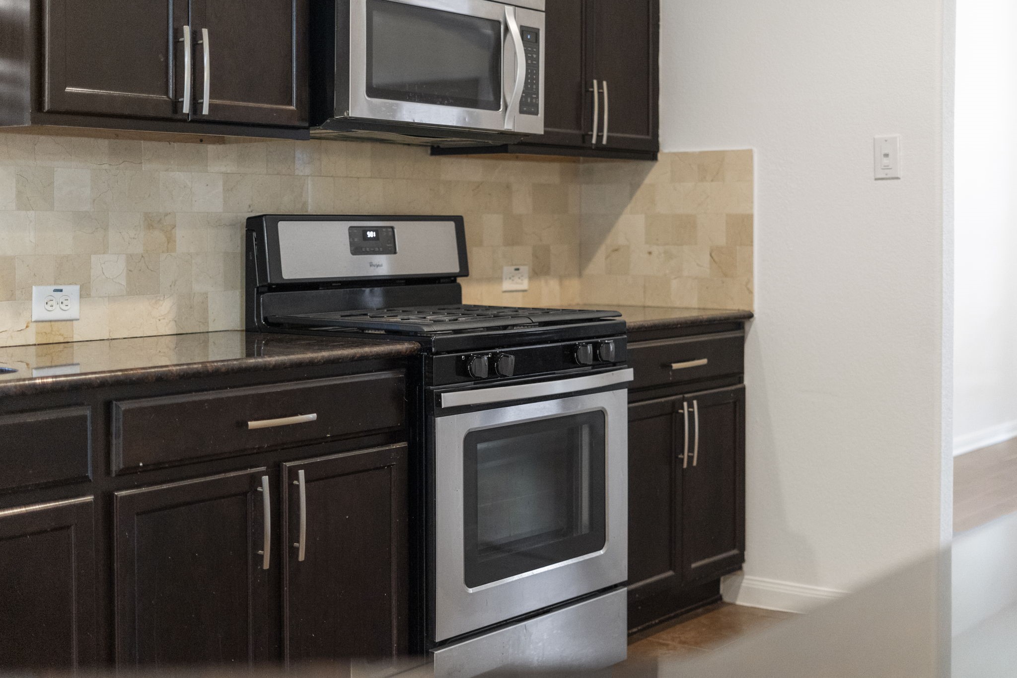 20555 Bonds Creek Lane Spring, TX 77388 - Photo 11 of 34 a kitchen with stainless steel appliances granite countertop a stove and a microwave