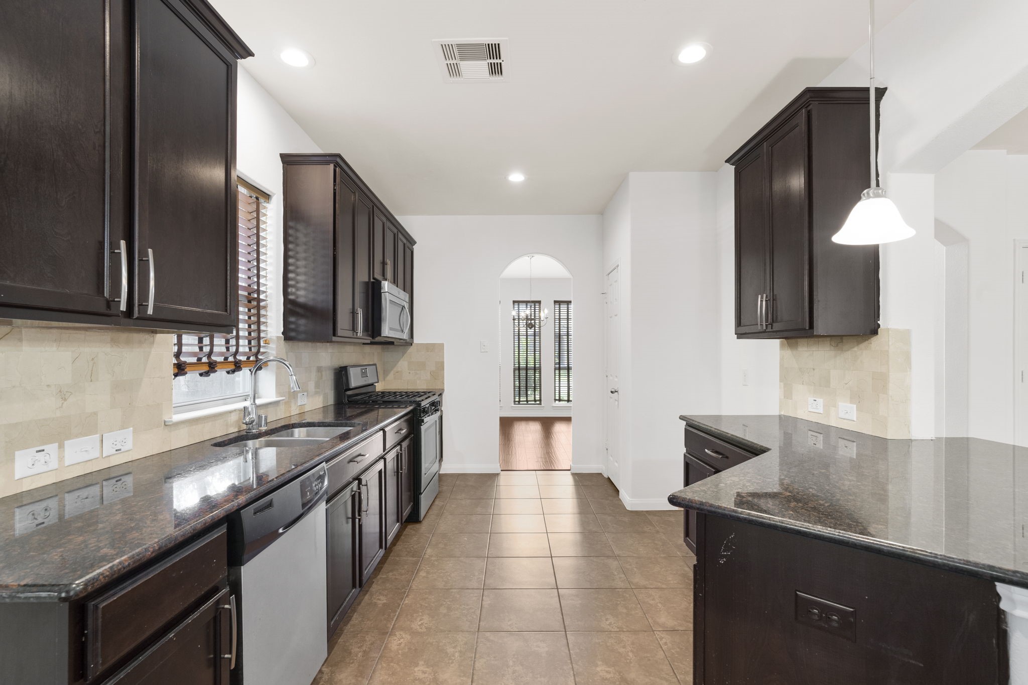 20555 Bonds Creek Lane Spring, TX 77388 - Photo 13 of 34 a kitchen with stainless steel appliances granite countertop a sink a stove and a refrigerator
