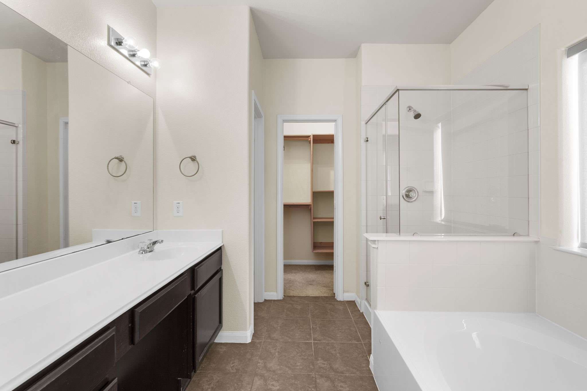 20555 Bonds Creek Lane Spring, TX 77388 - Photo 16 of 34 a bathroom with a tub sink and mirror