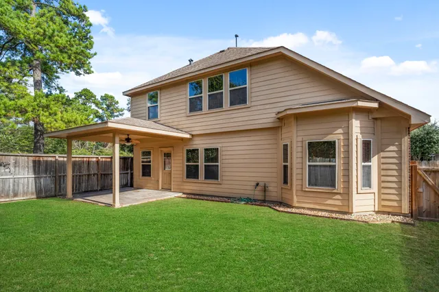 a view of a house with a yard and sitting area