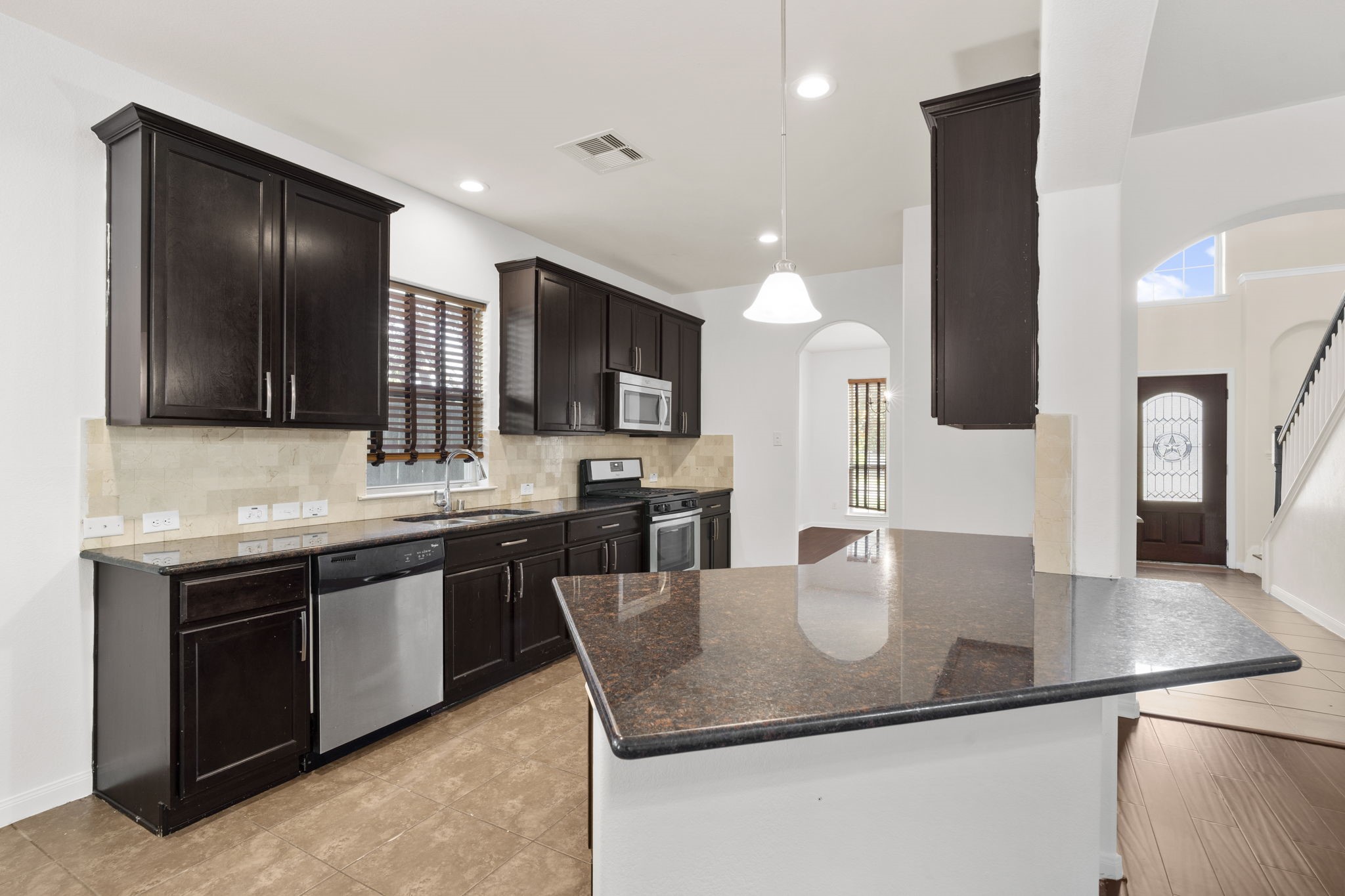 20555 Bonds Creek Lane Spring, TX 77388 - Photo 10 of 34 a kitchen with stainless steel appliances granite countertop a sink and a refrigerator