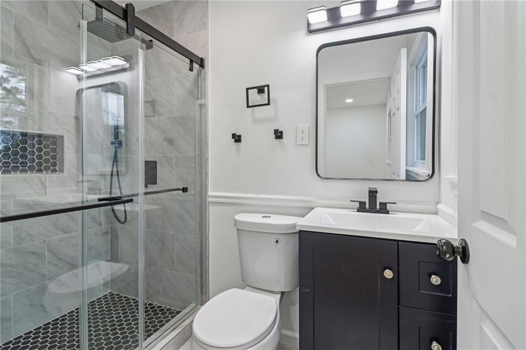 3159 Bobolink Drive Decatur, GA 30032 - Photo 11 of 37 a bathroom with a sink a toilet and shower