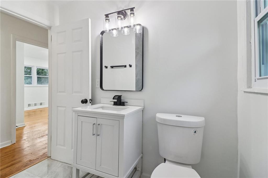 3159 Bobolink Drive Decatur, GA 30032 - Photo 13 of 37 a bathroom with a toilet a sink and mirror