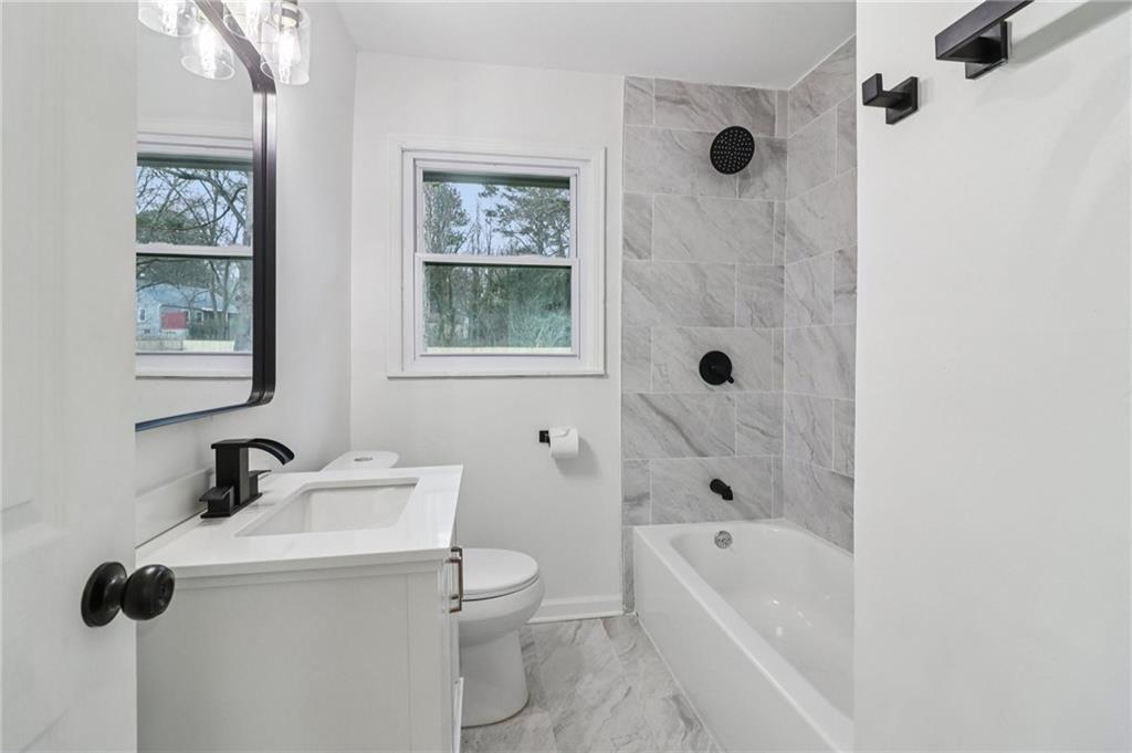 3159 Bobolink Drive Decatur, GA 30032 - Photo 15 of 37 a bathroom with a shower a sink a mirror a toilet and bathtub