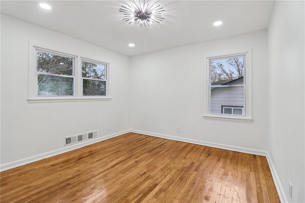 3159 Bobolink Drive Decatur, GA 30032 - Photo 22 of 37 a view of an empty room with wooden floor and a window