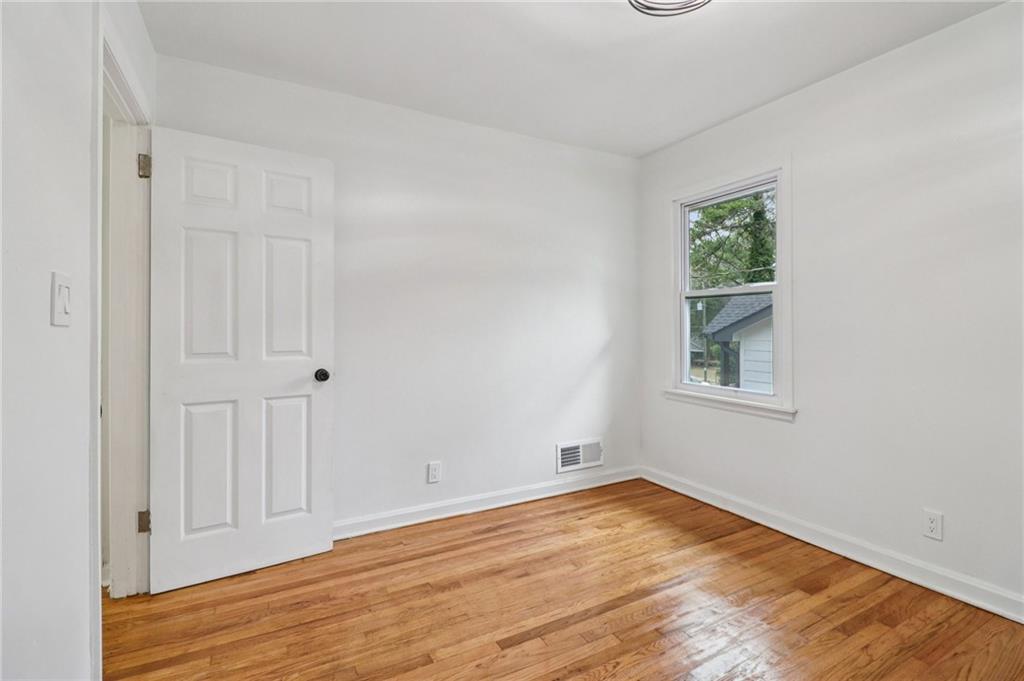3159 Bobolink Drive Decatur, GA 30032 - Photo 23 of 37 a view of empty room with wooden floor and fan