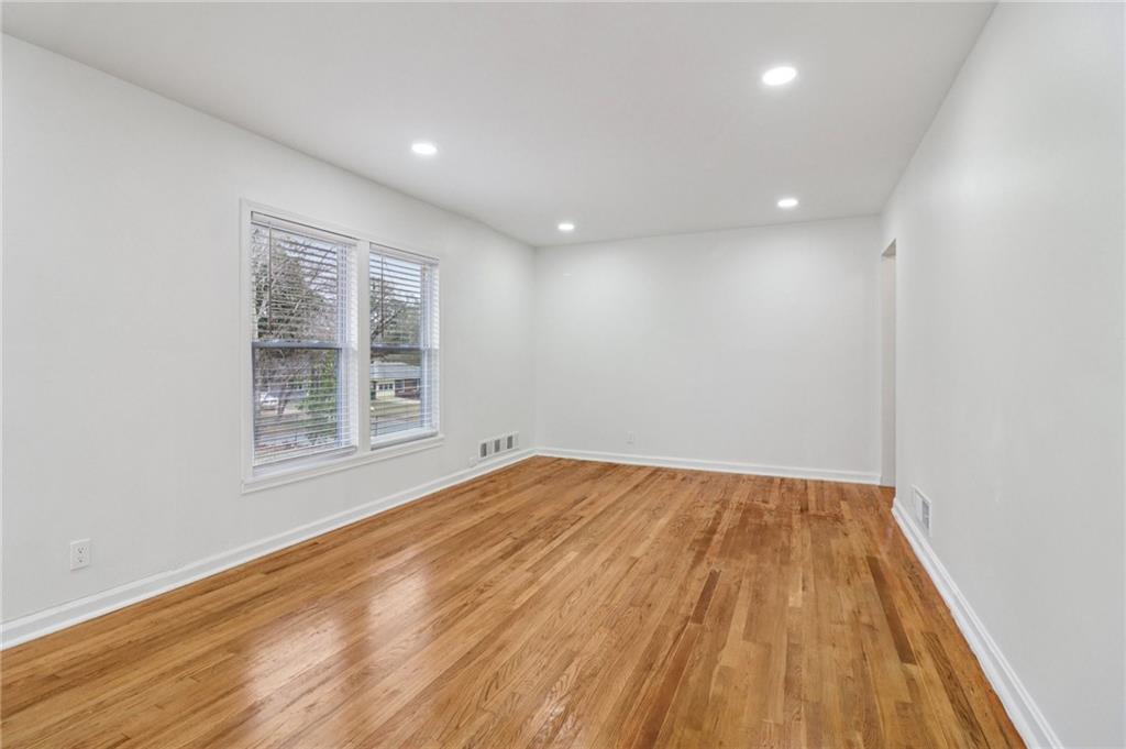 3159 Bobolink Drive Decatur, GA 30032 - Photo 33 of 37 an empty room with wooden floor and windows