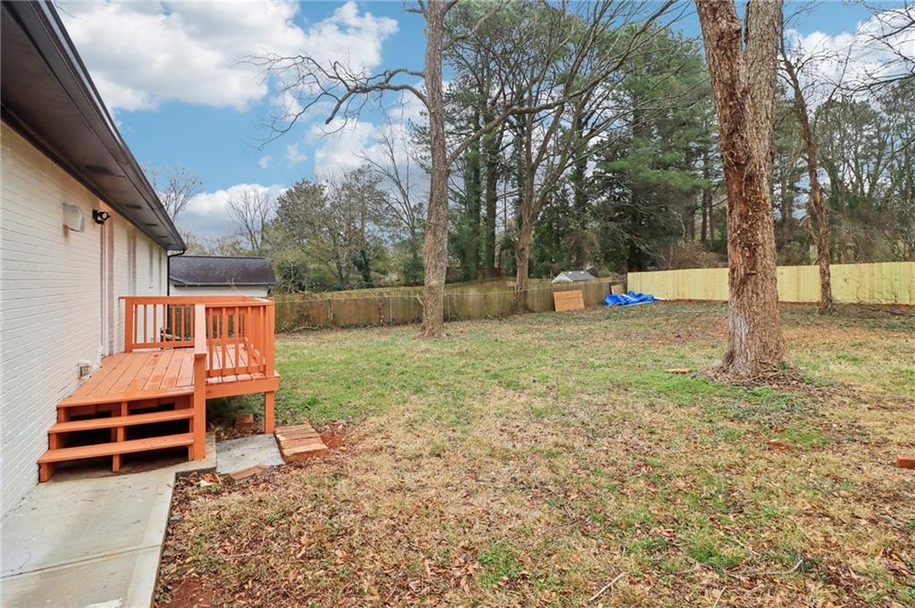 3159 Bobolink Drive Decatur, GA 30032 - Photo 35 of 37 a backyard of a house with barbeque oven and table and chairs