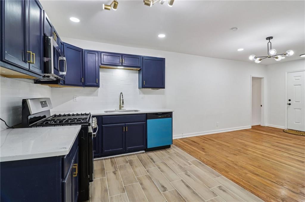 3159 Bobolink Drive Decatur, GA 30032 - Photo 6 of 37 a kitchen with stainless steel appliances granite countertop a sink stove and refrigerator