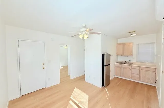 a spacious bedroom with a large bed and a chandelier