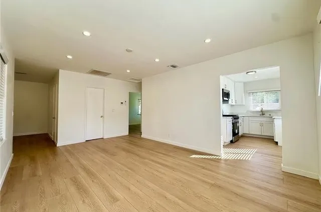 a view of a kitchen with a sink and a refrigerator