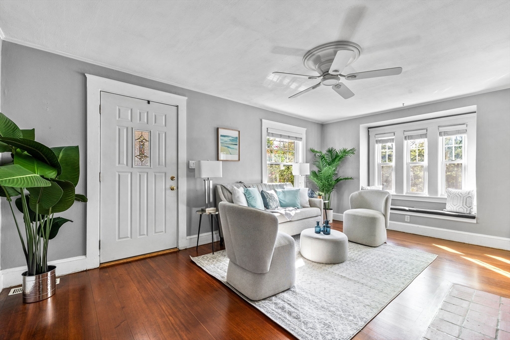 92 Old Connecticut Path Framingham, MA 01701 - Photo 2 of 24 a living room with a couch and a potted plant