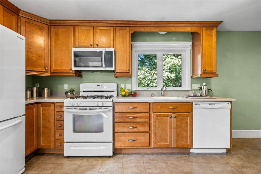92 Old Connecticut Path Framingham, MA 01701 - Photo 7 of 24 a kitchen with stainless steel appliances granite countertop a stove a sink and a microwave