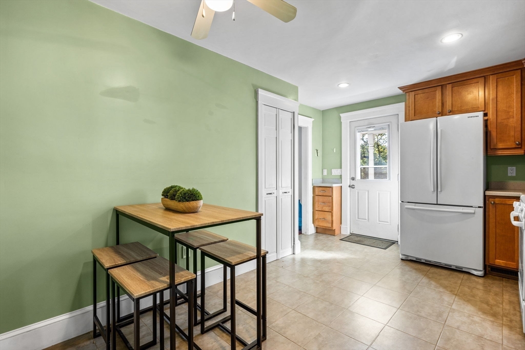 92 Old Connecticut Path Framingham, MA 01701 - Photo 9 of 24 a kitchen with a refrigerator a table and chairs