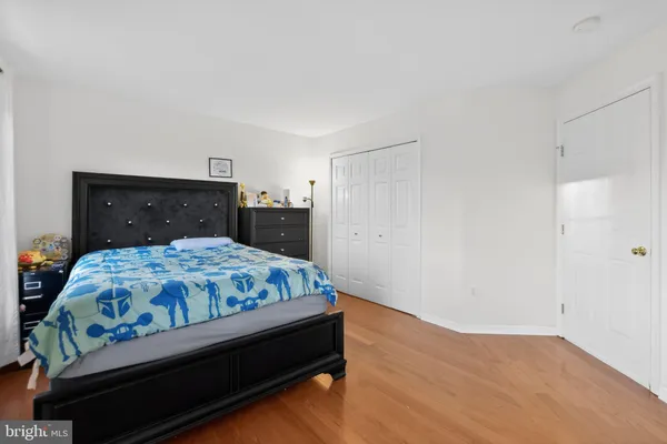 a bedroom with a bed and a dresser