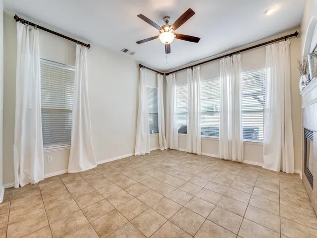 a view of a livingroom with a ceiling fan and window