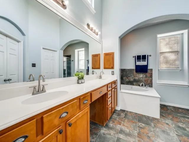 a bathroom with a sink double vanity and a mirror