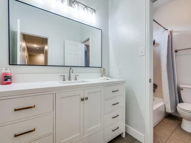 a bathroom with a sink vanity and a mirror