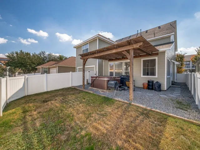 a view of a house with a yard and sitting area