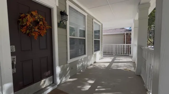 a view of a house with a door and wooden door