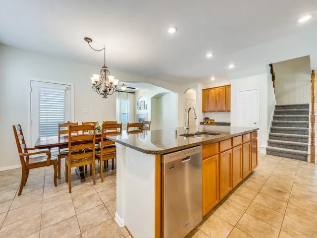 a kitchen with cabinets and chairs in it