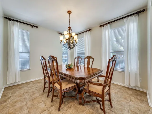 a view of a dining room with furniture and chandelier