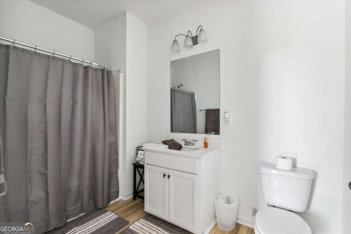1449 Proust Lane, Unit 1449 Stockbridge, GA 30281 - Photo 17 of 19 a bathroom with a sink toilet and shower