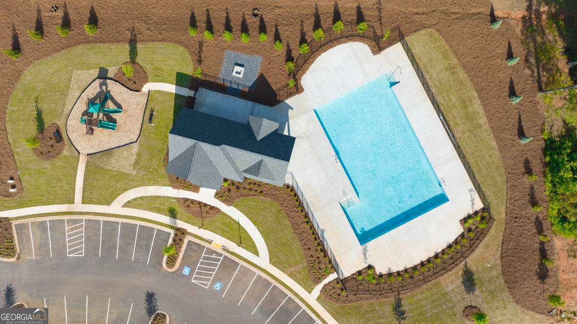 1449 Proust Lane, Unit 1449 Stockbridge, GA 30281 - Photo 18 of 19 a view of a swimming pool with a chairs