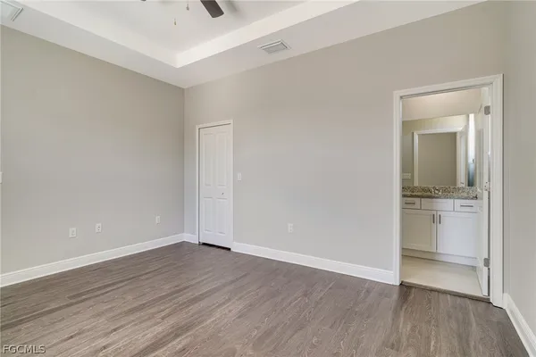 a bathroom with a granite countertop sink a toilet and shower