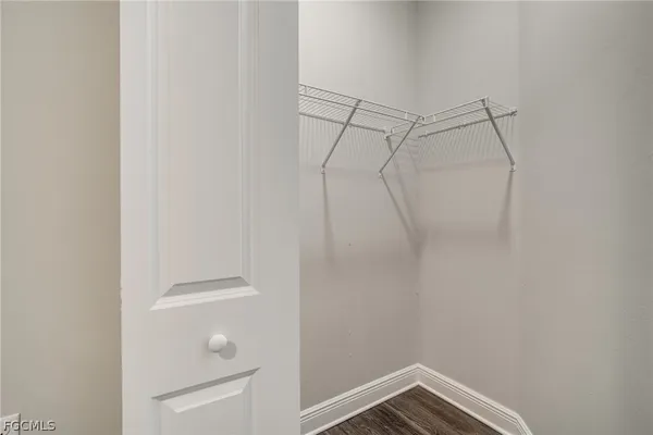 a view of empty room with white walls and windows