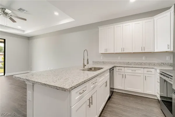 a kitchen with white cabinets and appliances