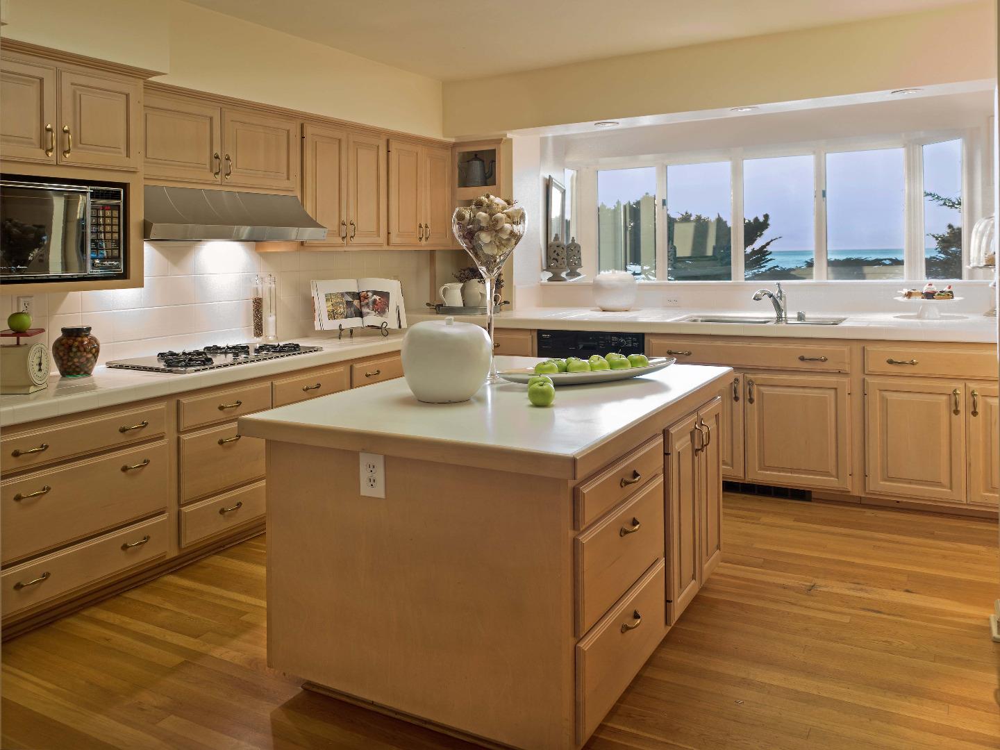 1000 Rodeo Road Pebble Beach, CA 93953 - Photo 13 of 28 a kitchen with stainless steel appliances granite countertop a sink stove and cabinets