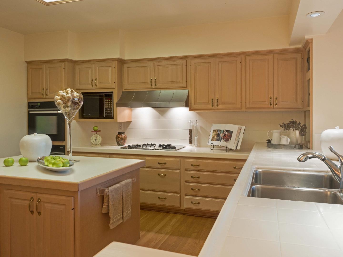 1000 Rodeo Road Pebble Beach, CA 93953 - Photo 14 of 28 a kitchen with a sink a stove and cabinets