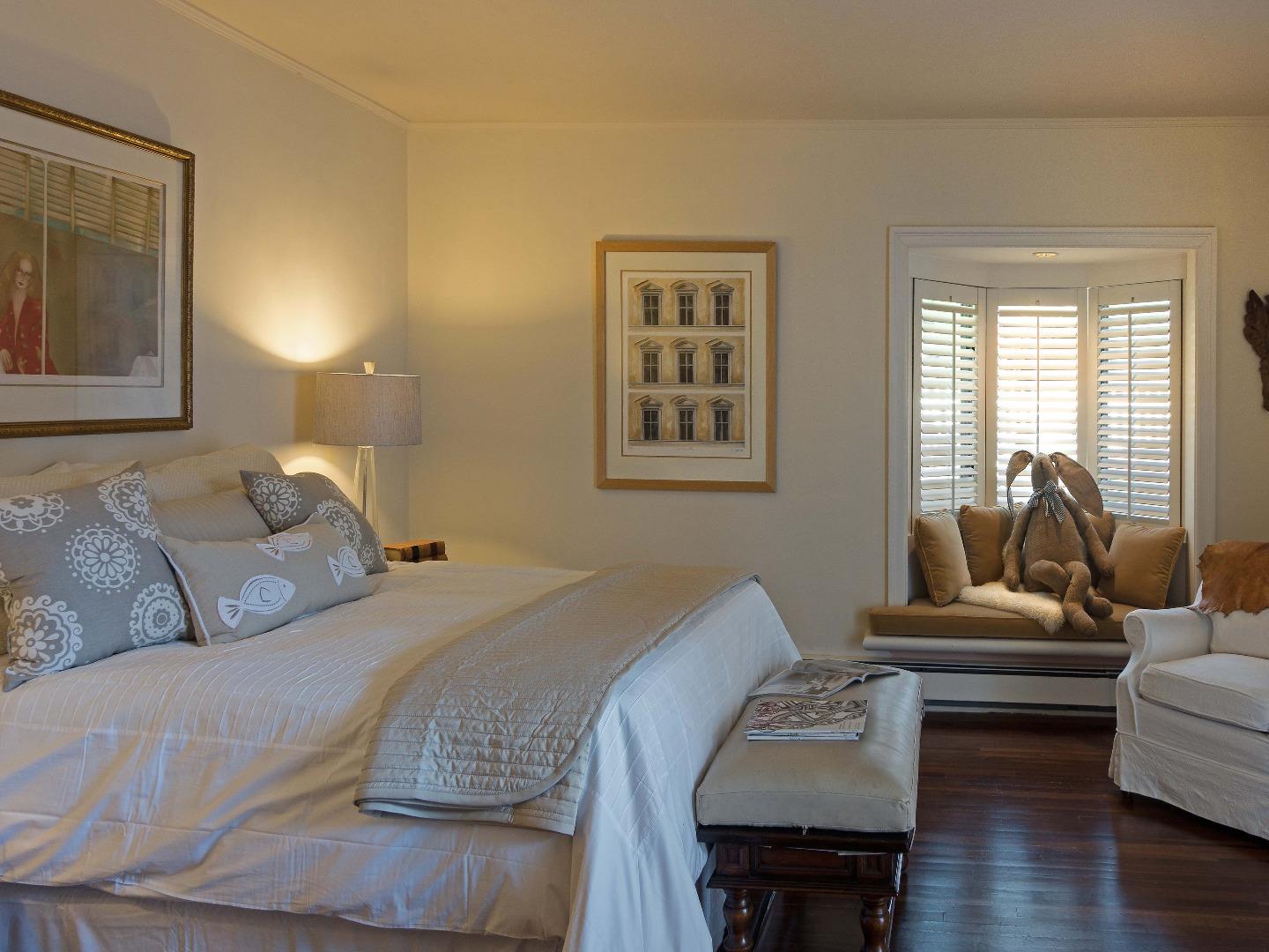 1000 Rodeo Road Pebble Beach, CA 93953 - Photo 20 of 28 a bedroom with a bed and wooden floor