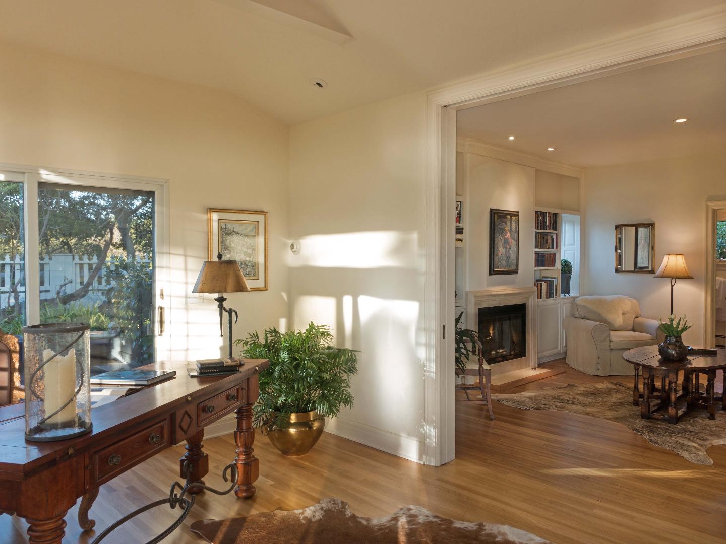 1000 Rodeo Road Pebble Beach, CA 93953 - Photo 10 of 28 a living room with furniture a fireplace and a floor to ceiling window