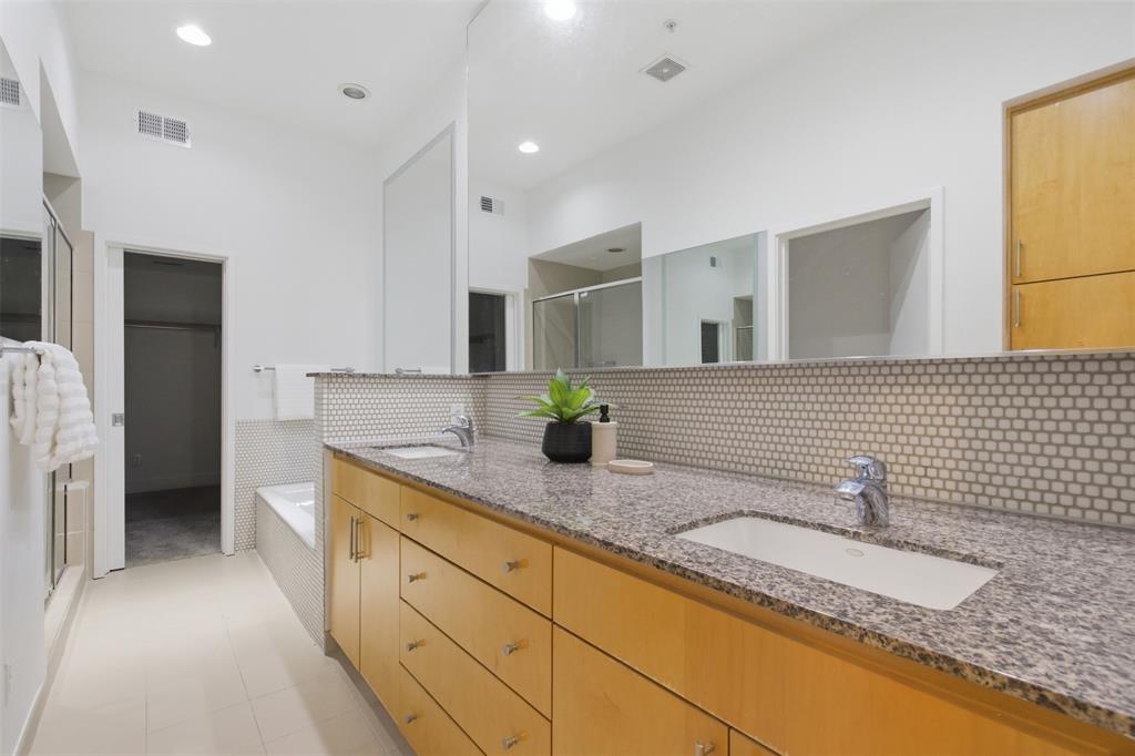 2111 Clark Street, Unit H Dallas, TX 75204 - Photo 10 of 37 a bathroom with a granite countertop sink and a mirror