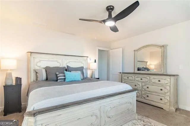 a bedroom with a large bed and a dresser