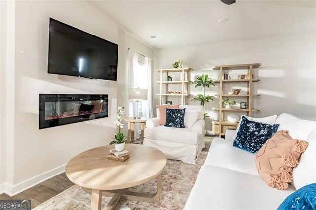a living room with furniture and a flat screen tv