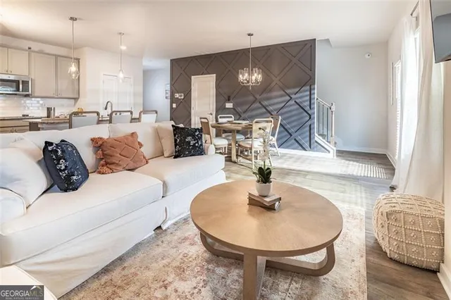 a living room with furniture and a dining table